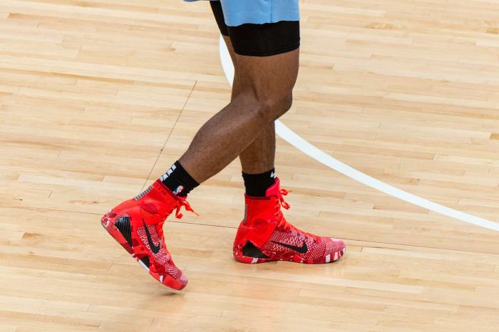 Side view of Kobe Bryant's red and white Nike sneakers.